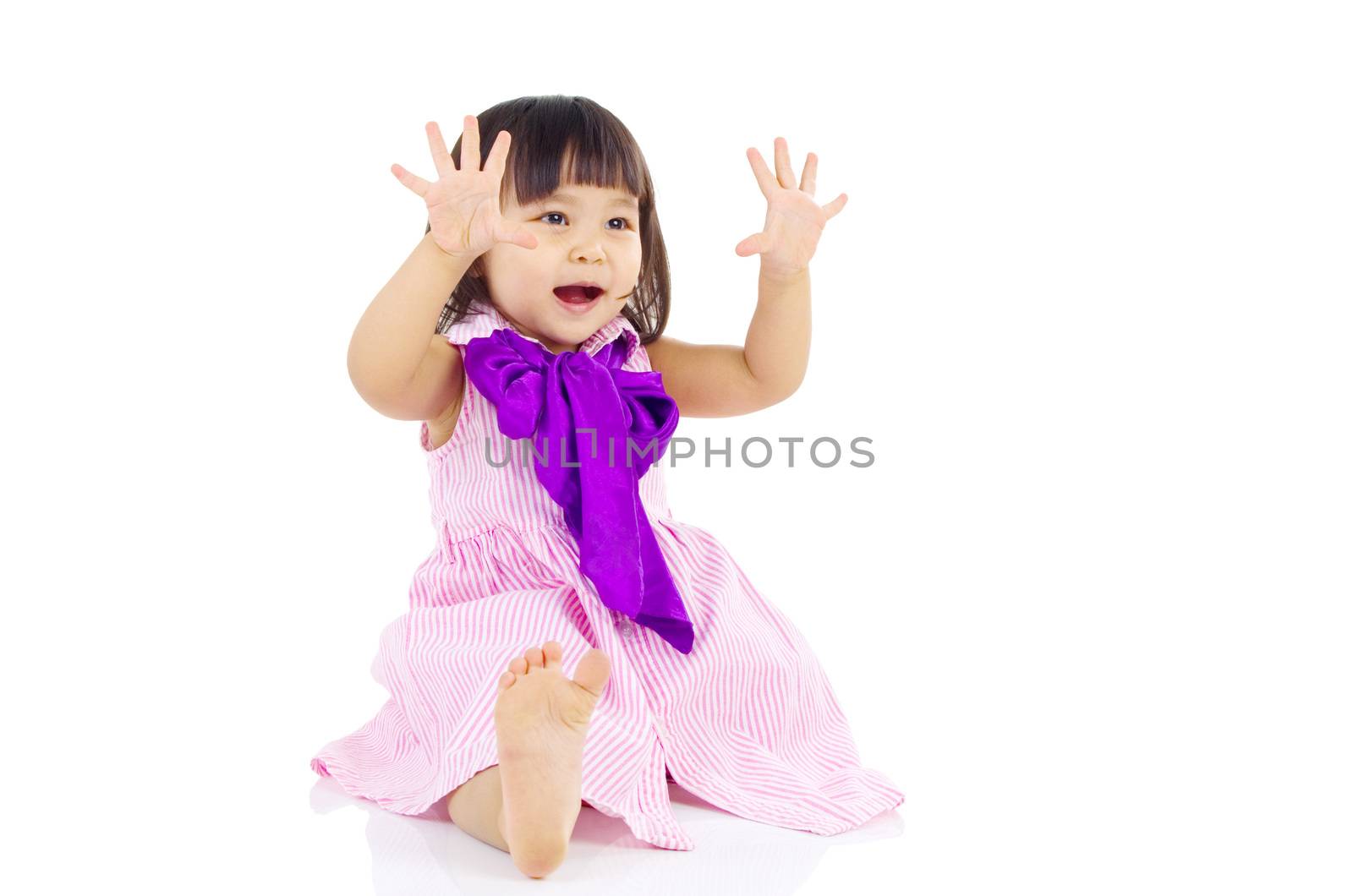 Cute asian girl sitting on the floor and smiling