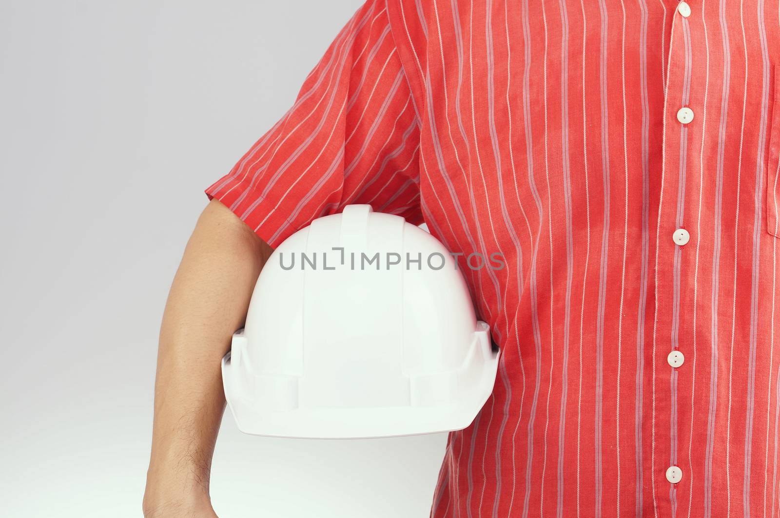 Engineer with red shirt hold white engineer hat on white background.