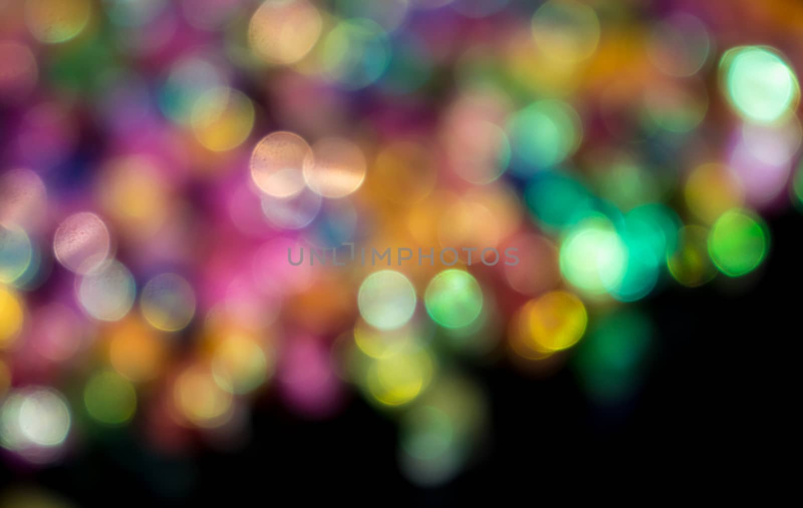 bokeh from colorful star paper on black background