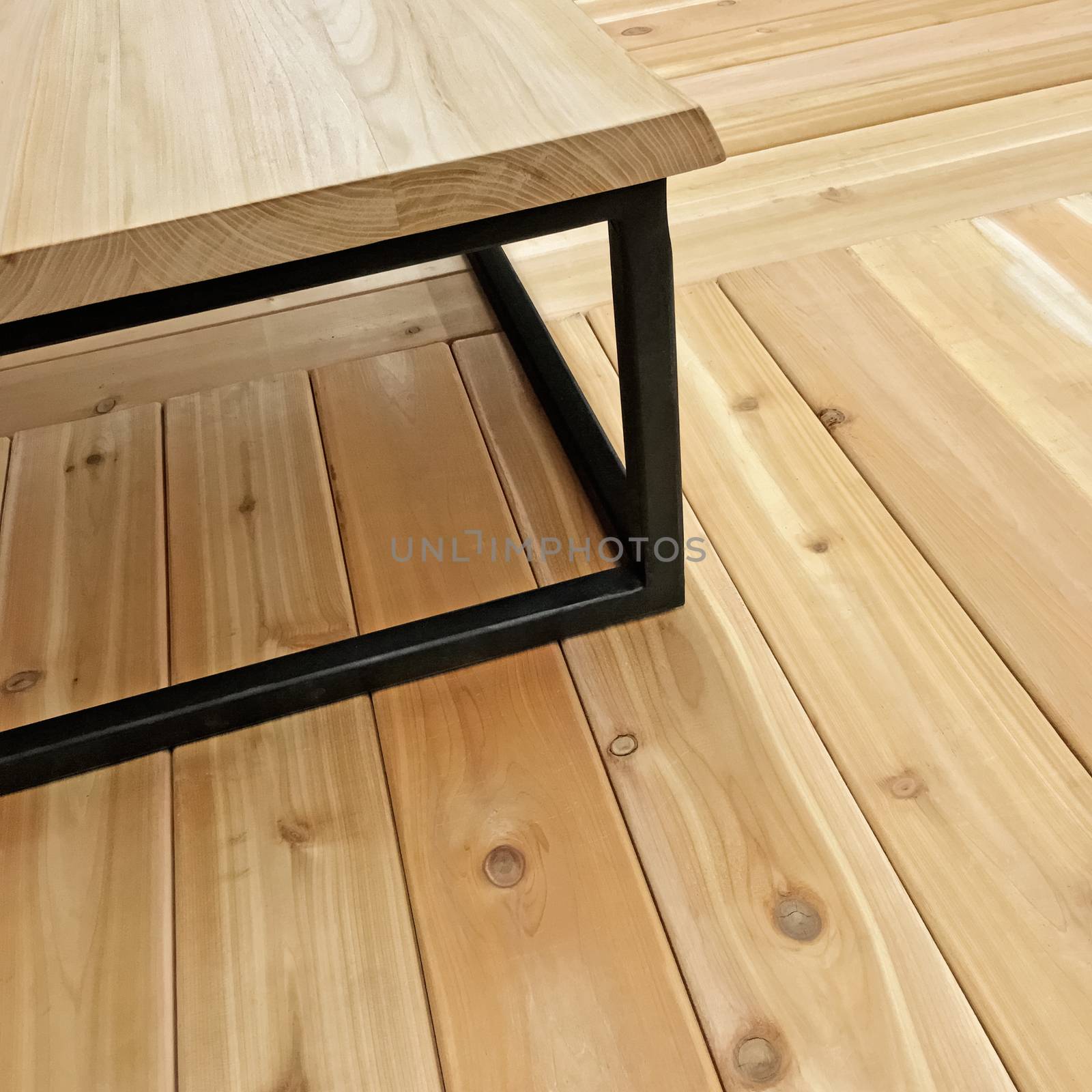 Simple table on wooden floor. Modern style furniture.