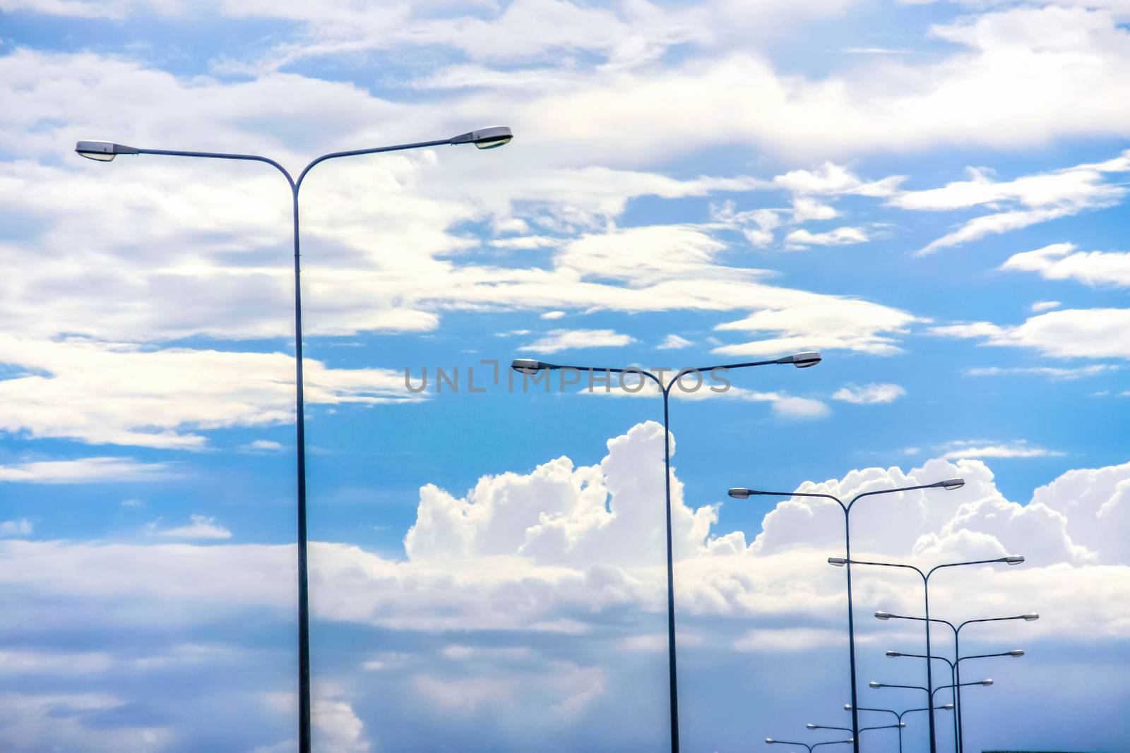 Light pole on beautiful white cloud and blue sky