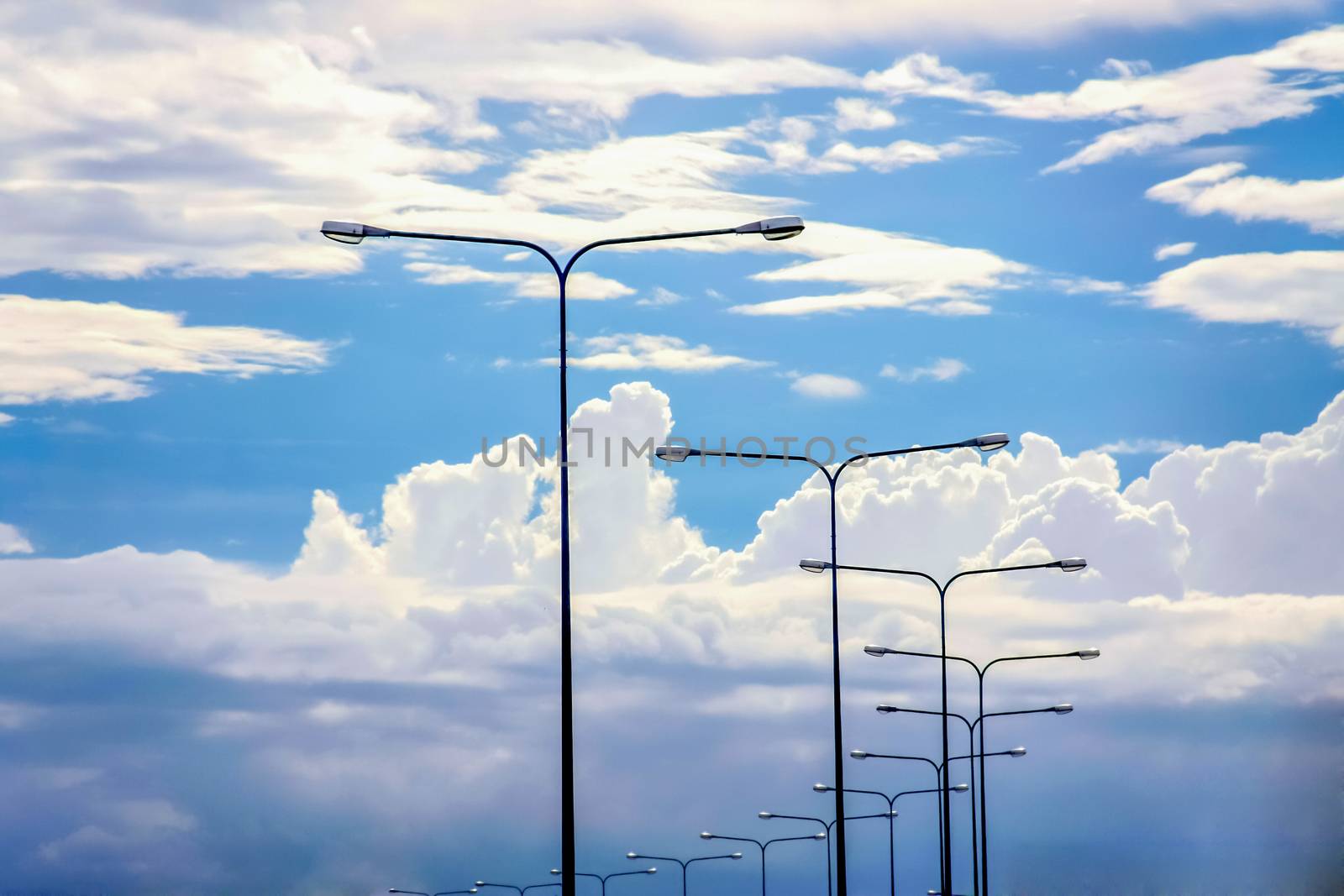 Light pole on beautiful white cloud and blue sky