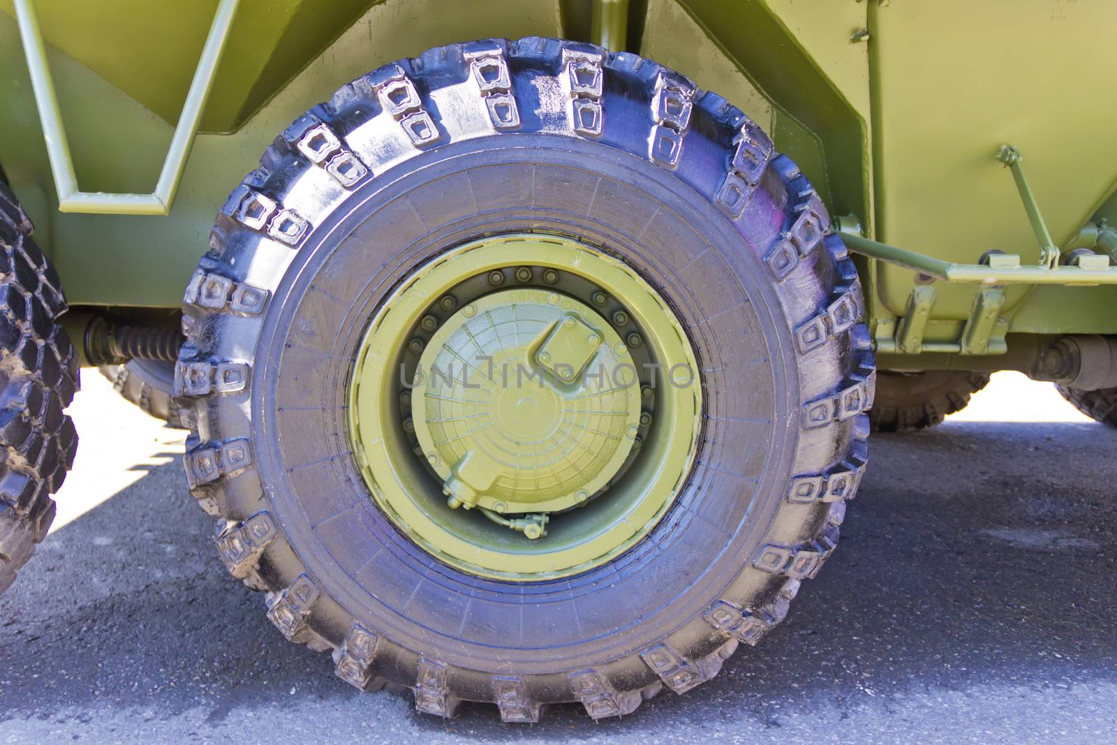 Wheel of military machine at the exhibition under open sky