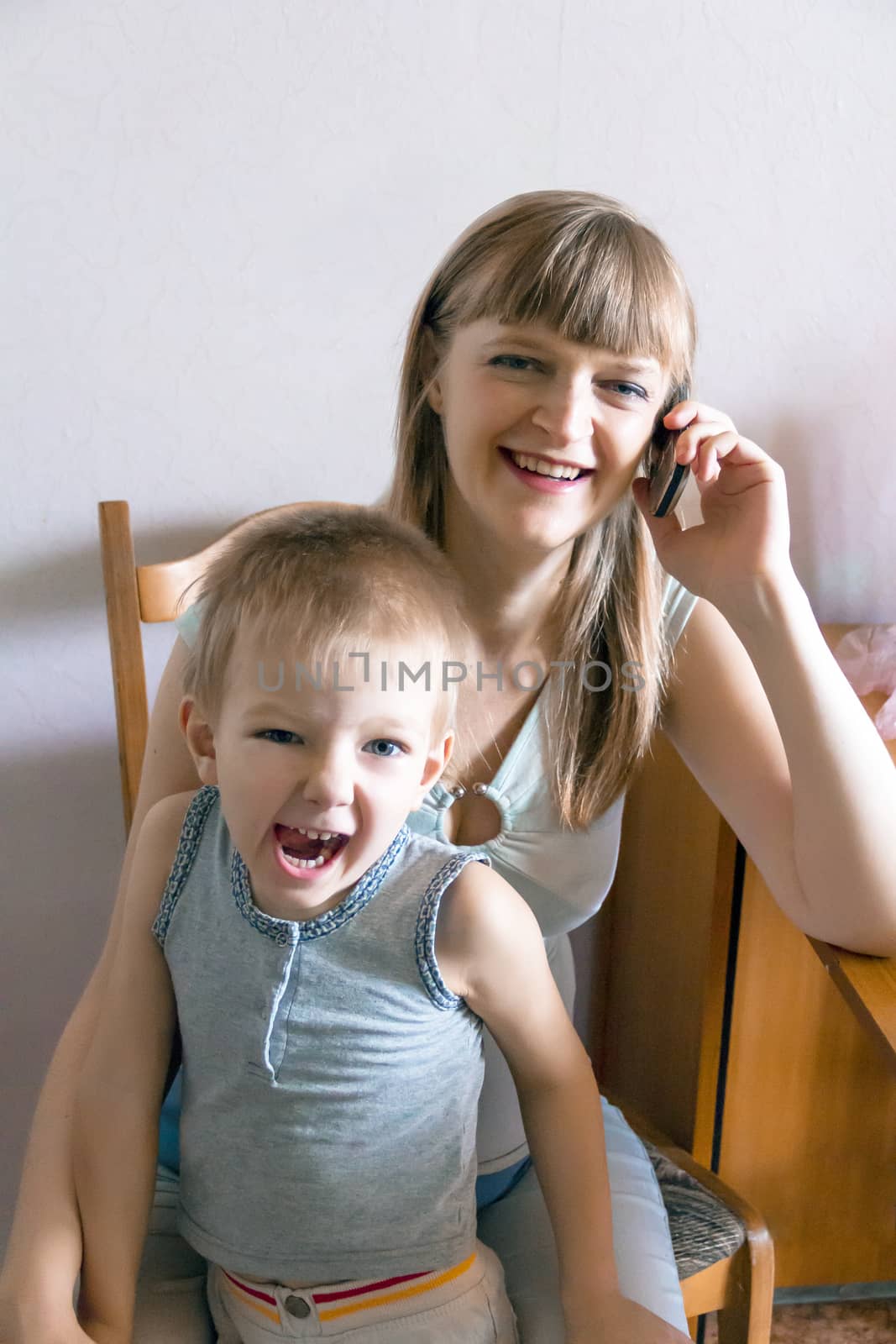 Pregnant woman talking by mobile with angry son