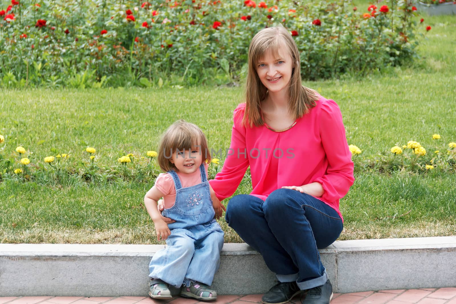 Mother and daughter in summer green park