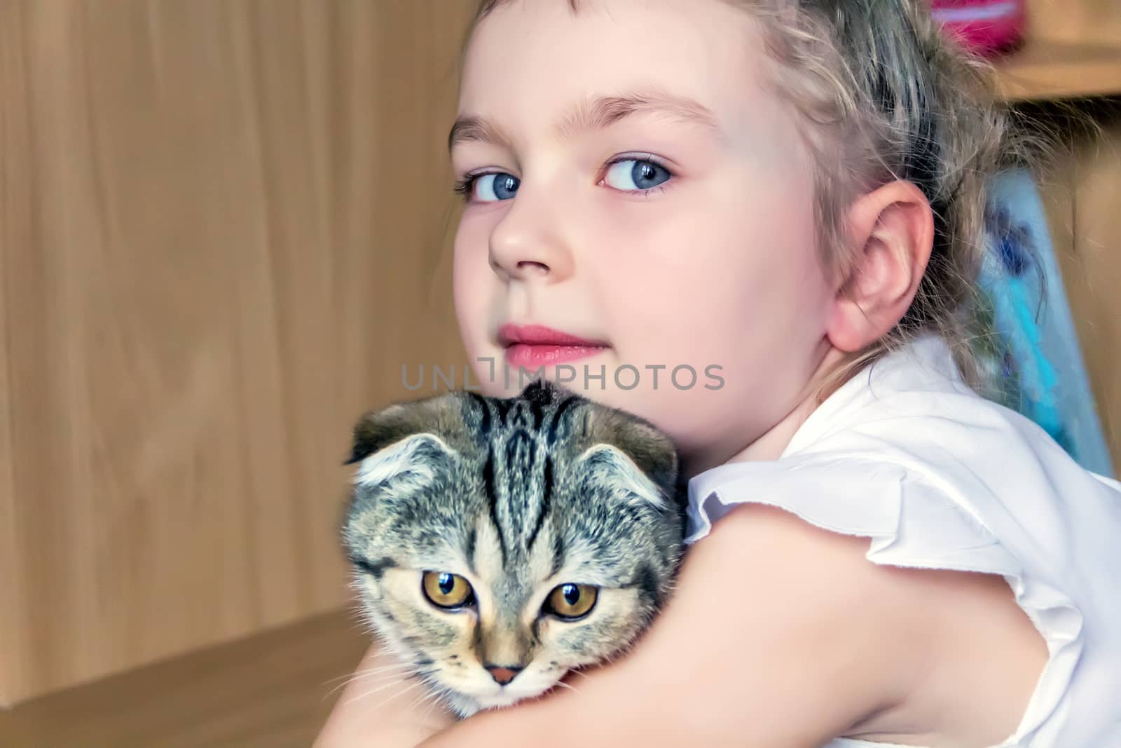 Blond girl with grey kitty in white