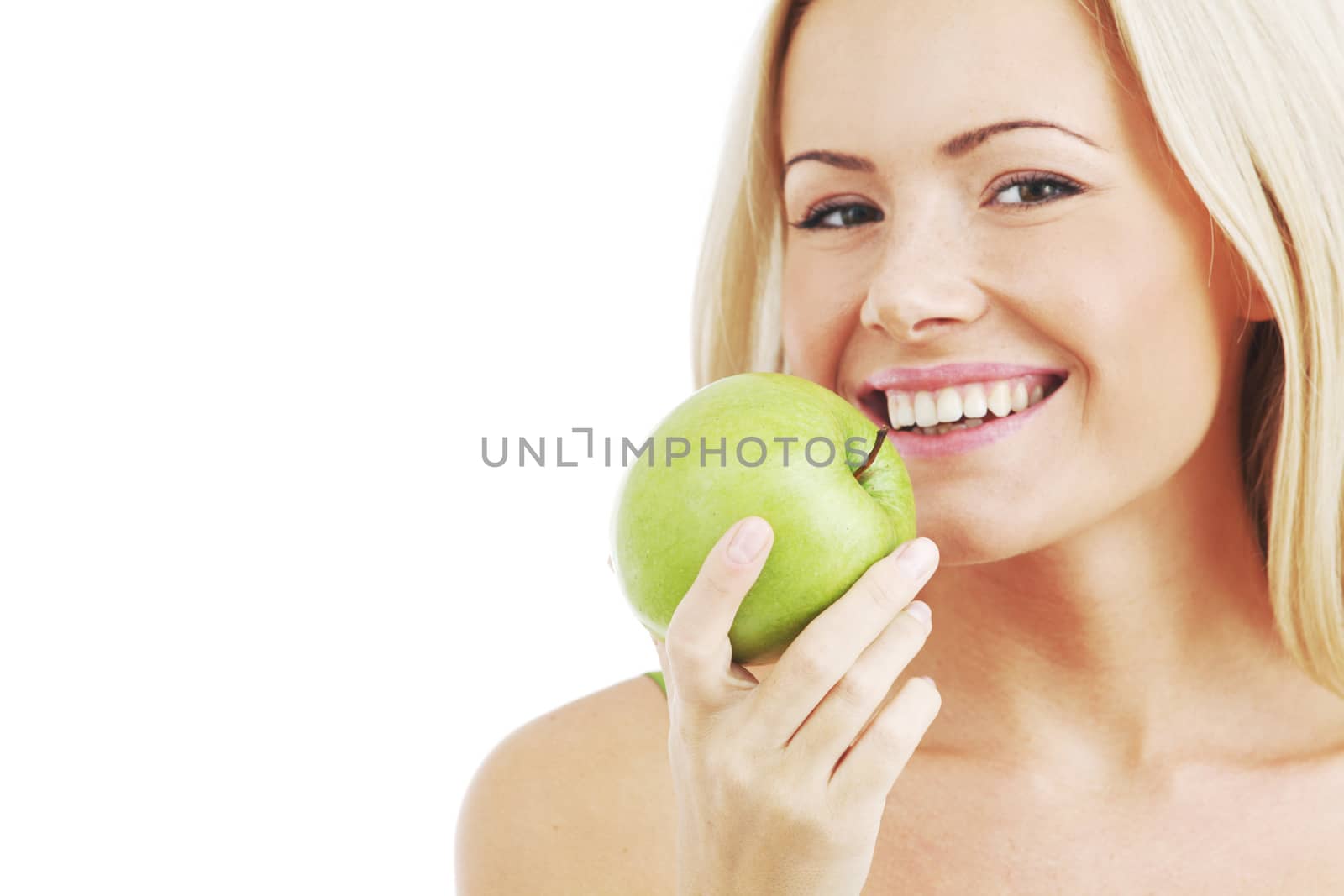 blond woman eat green apple on white