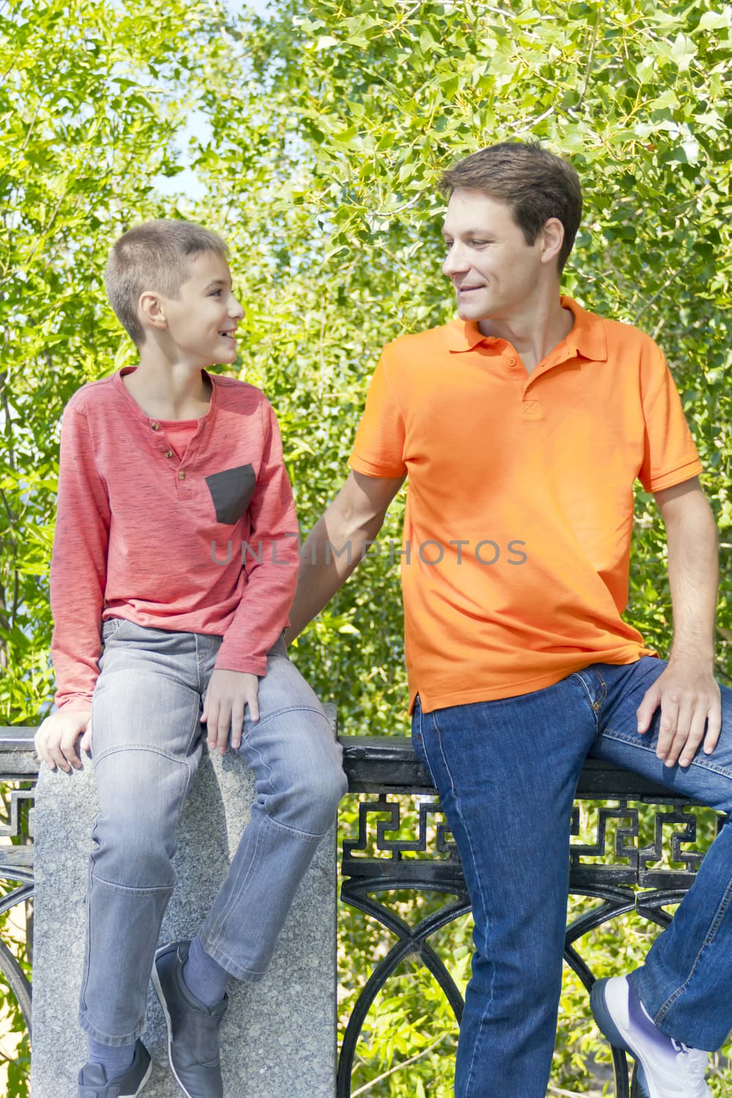 Man and boy are talking looking to each others in summer