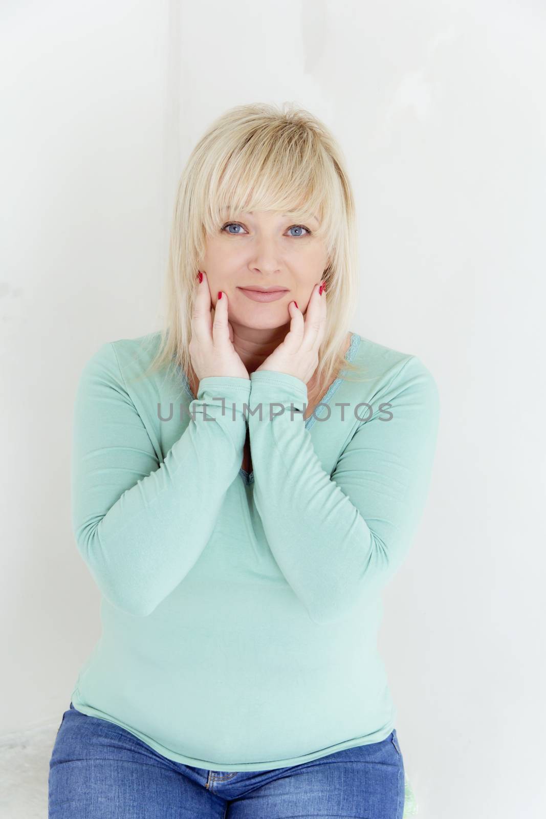 European blond woman with blue eyes in green