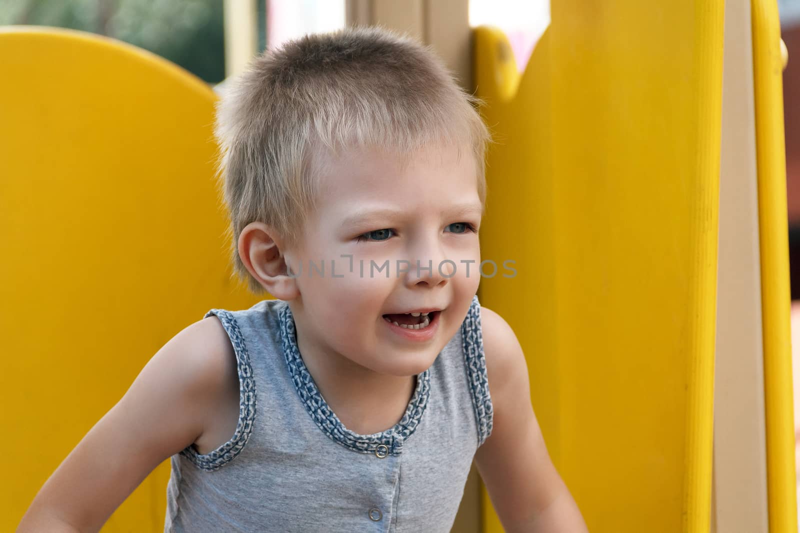 Portrait of cute blond boy with open mouth