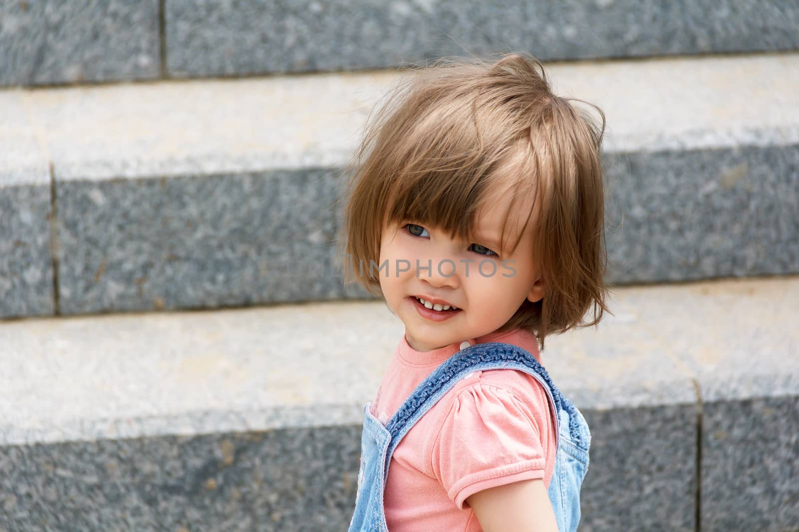 Portrait of baby girl on the stairs background