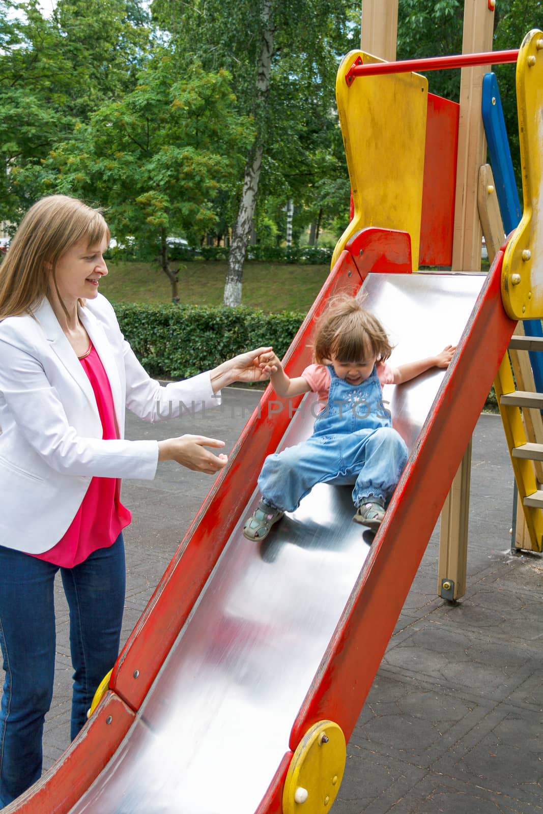 Mother with baby girl riding on hutches with screw up one eyes