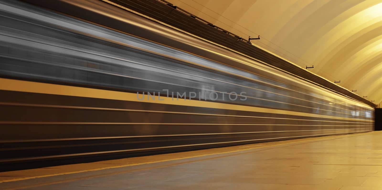 Subway platform with moving fast train