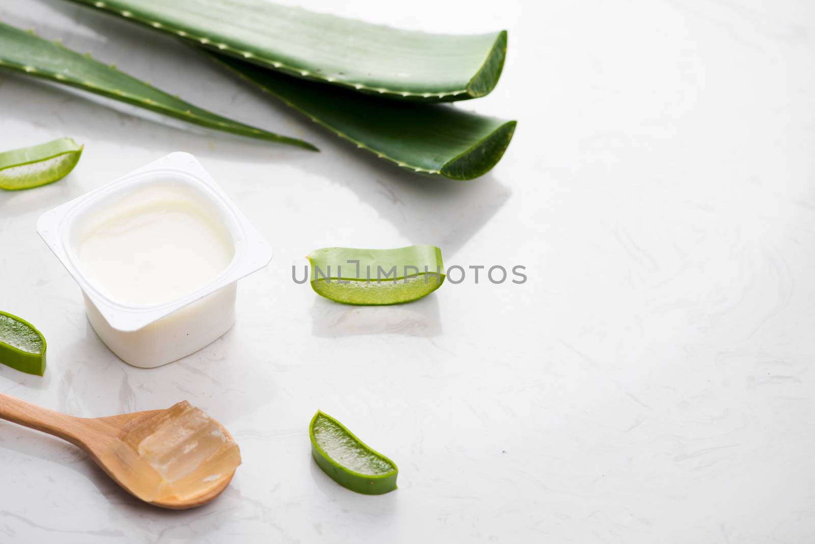 Aloe vera yogurt with fresh leaves on a wooden table