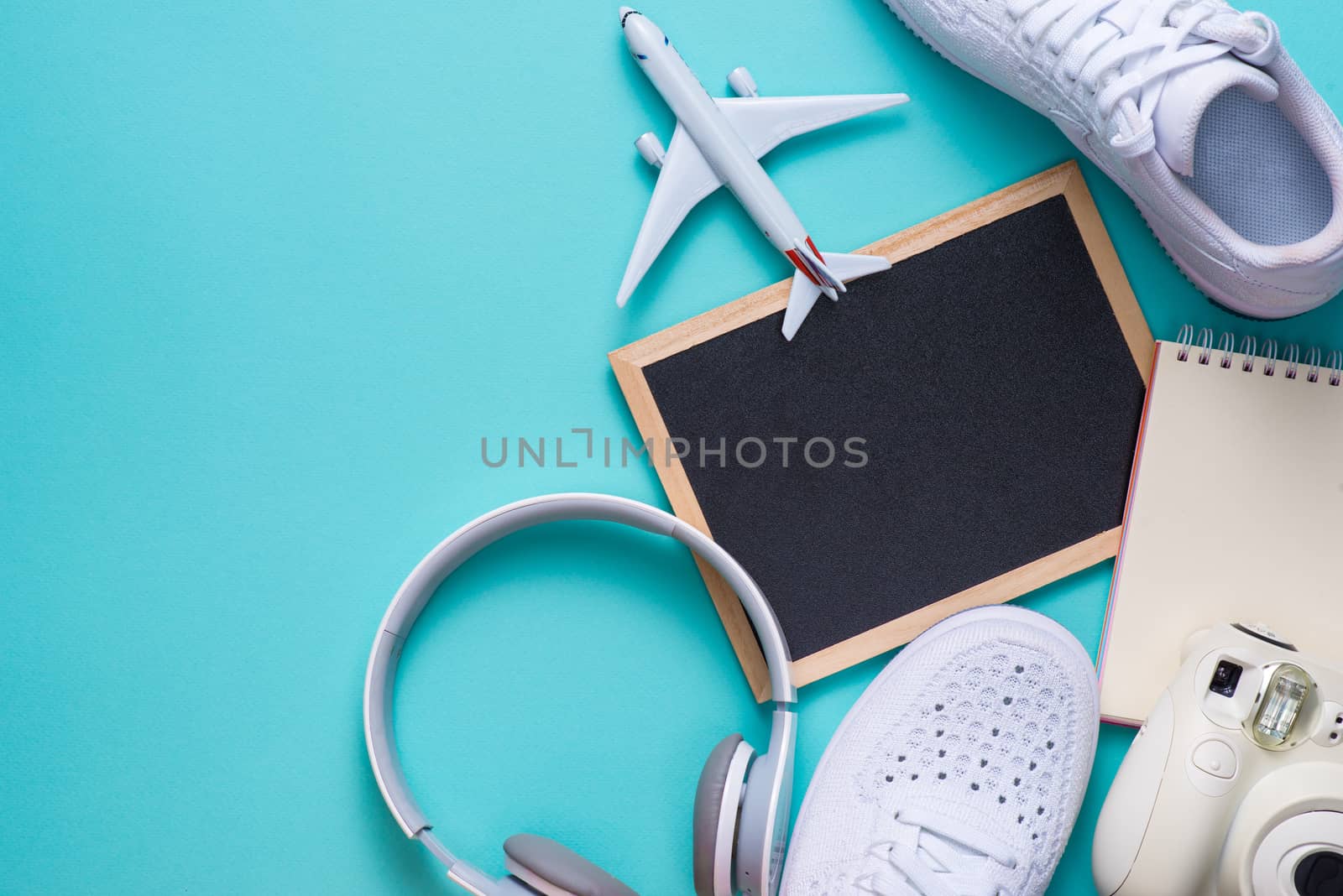 Vacation concept. Top view of travel accessories set on wooden background with copy space