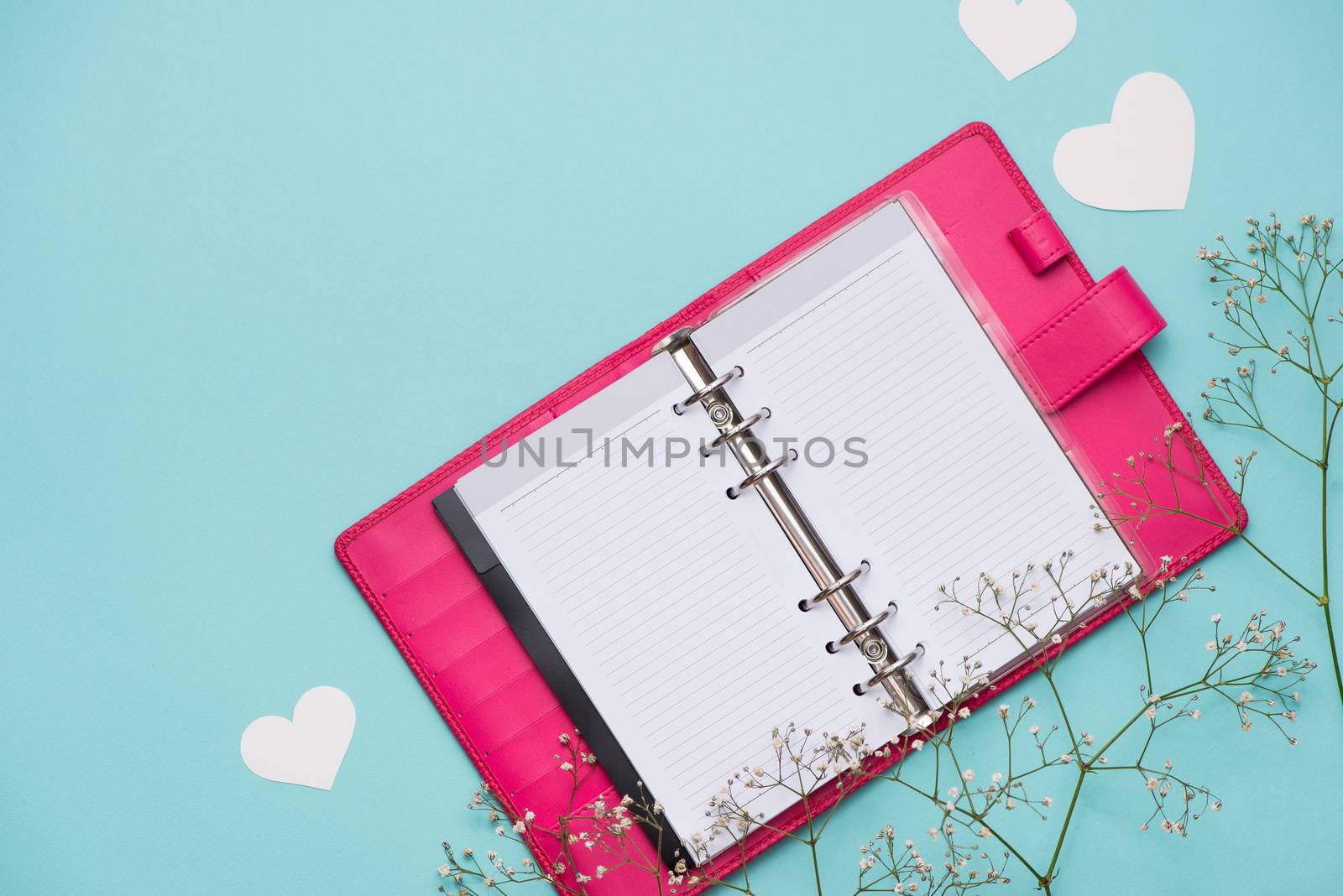 Mother's Day concept. Pink roses with gift box. Open notebook for copy space.