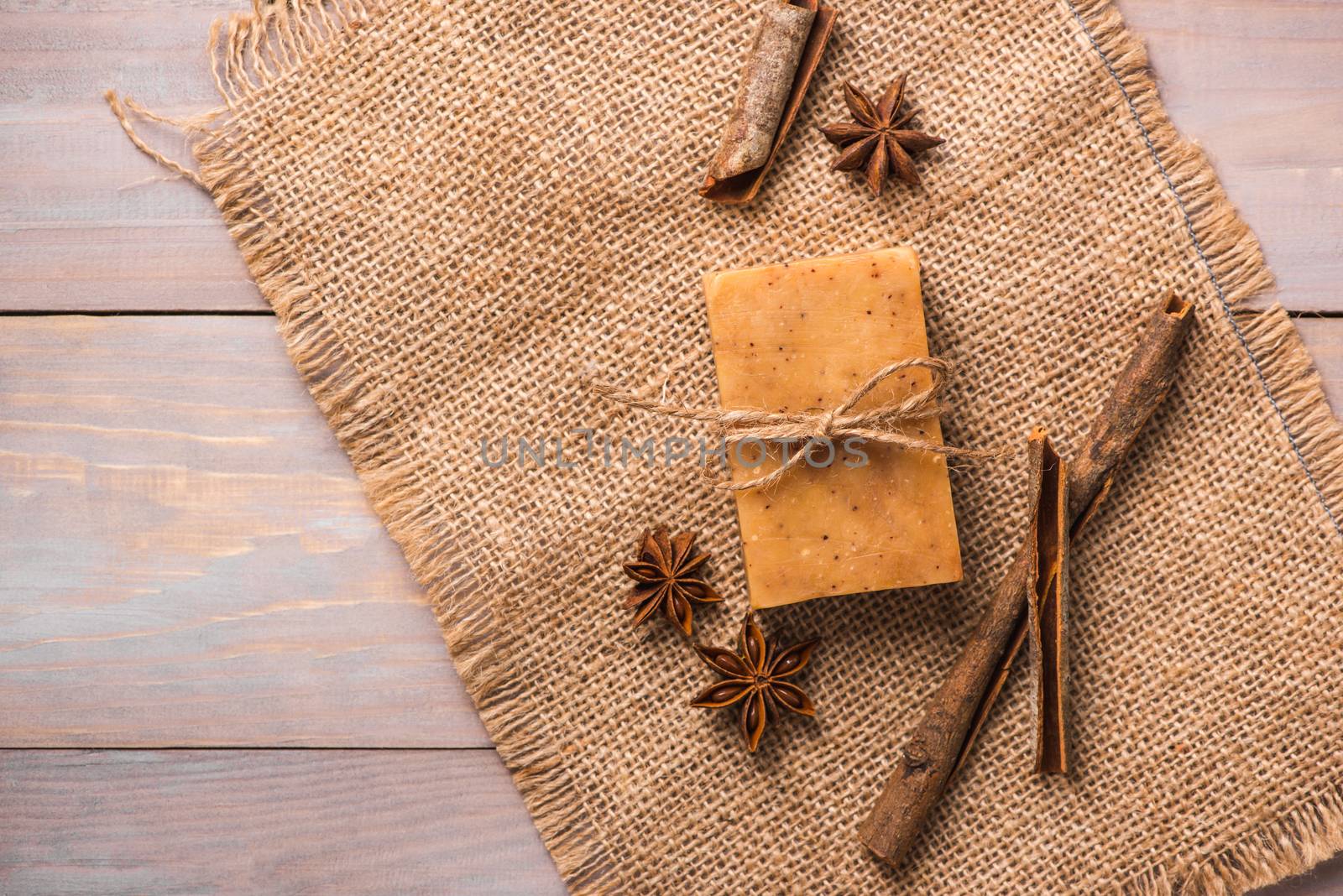 Handmade soap with cinnamon and anise star on wooden background. by makidotvn