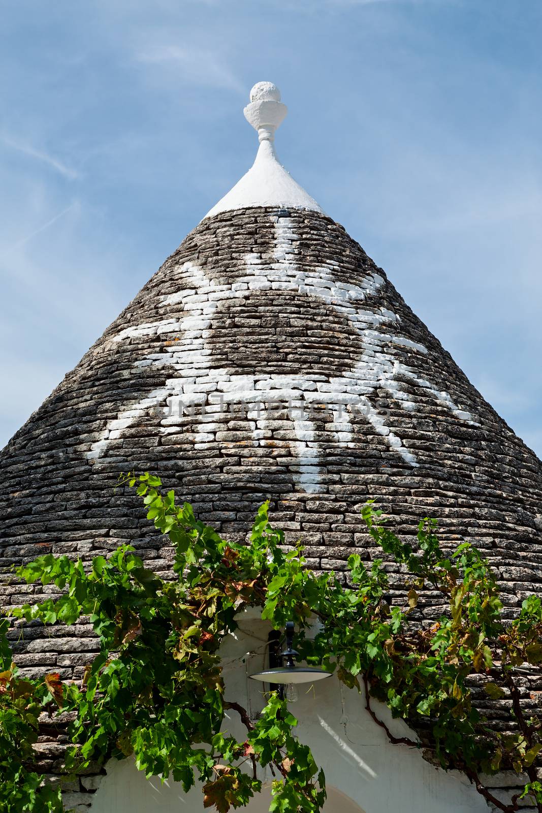 Symbol in the Trullo conical rooftop in Alberobello, Puglia, Ita by LuigiMorbidelli