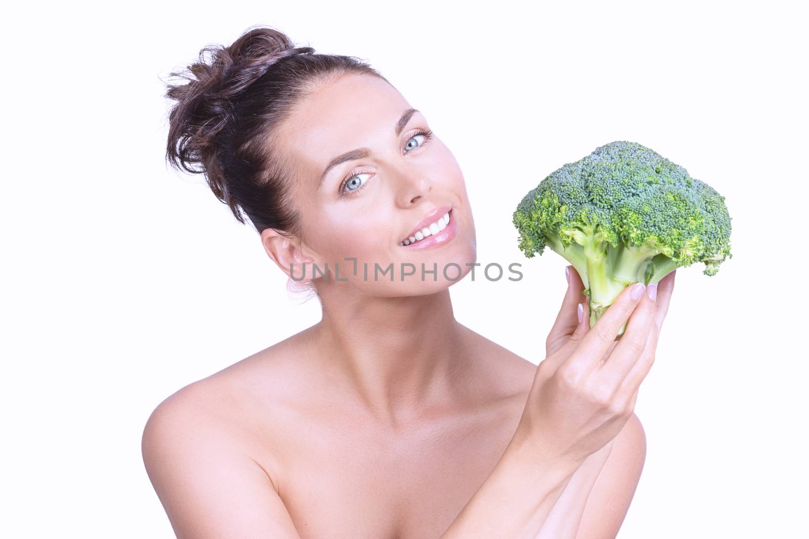 Portrait of a beautiful woman with perfect skin holding broccoli, isolated on white background