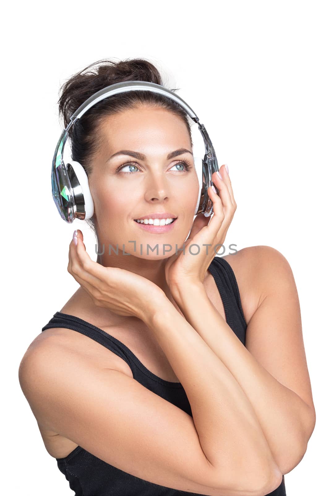 Young smiling woman listening to music with headphones, isolated on white background