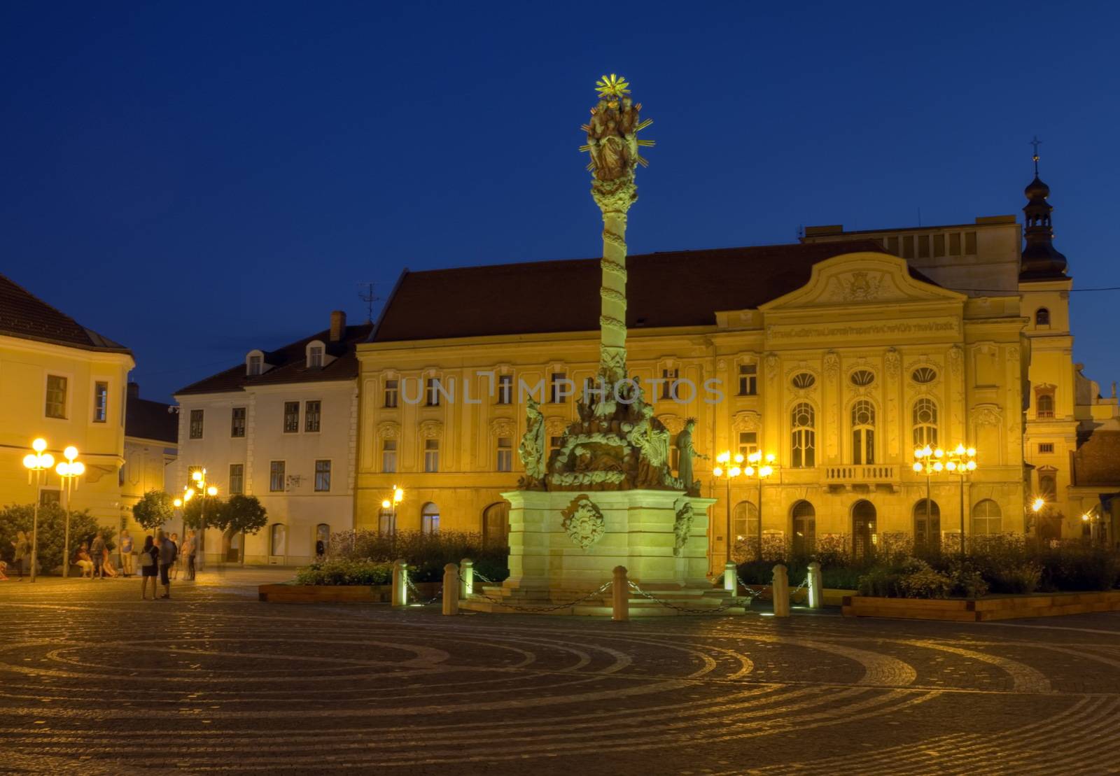 Plague column on Holy Trinity square by night in Trnava, Slovakia