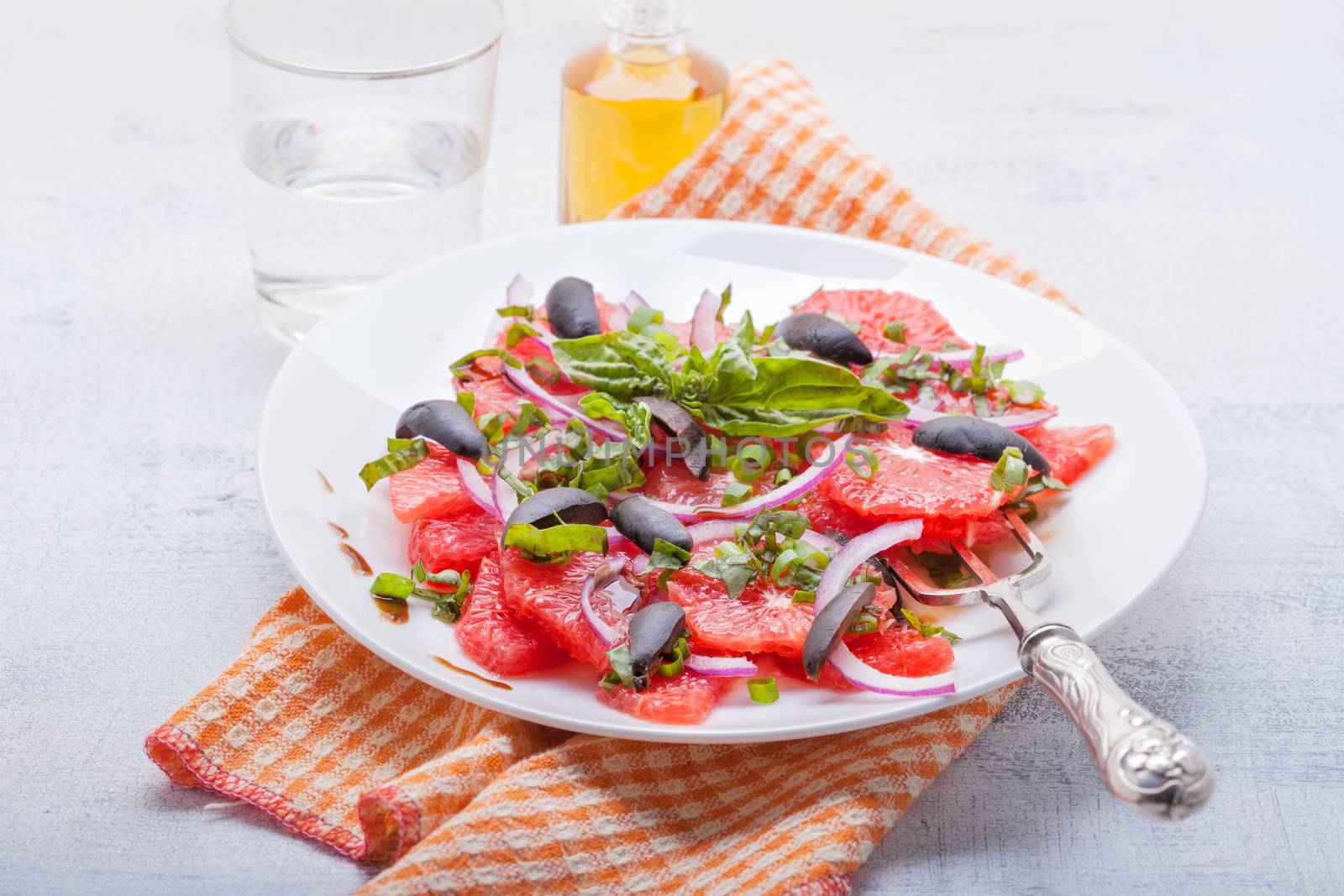 Grapefruit salad with olives, red onion, basil