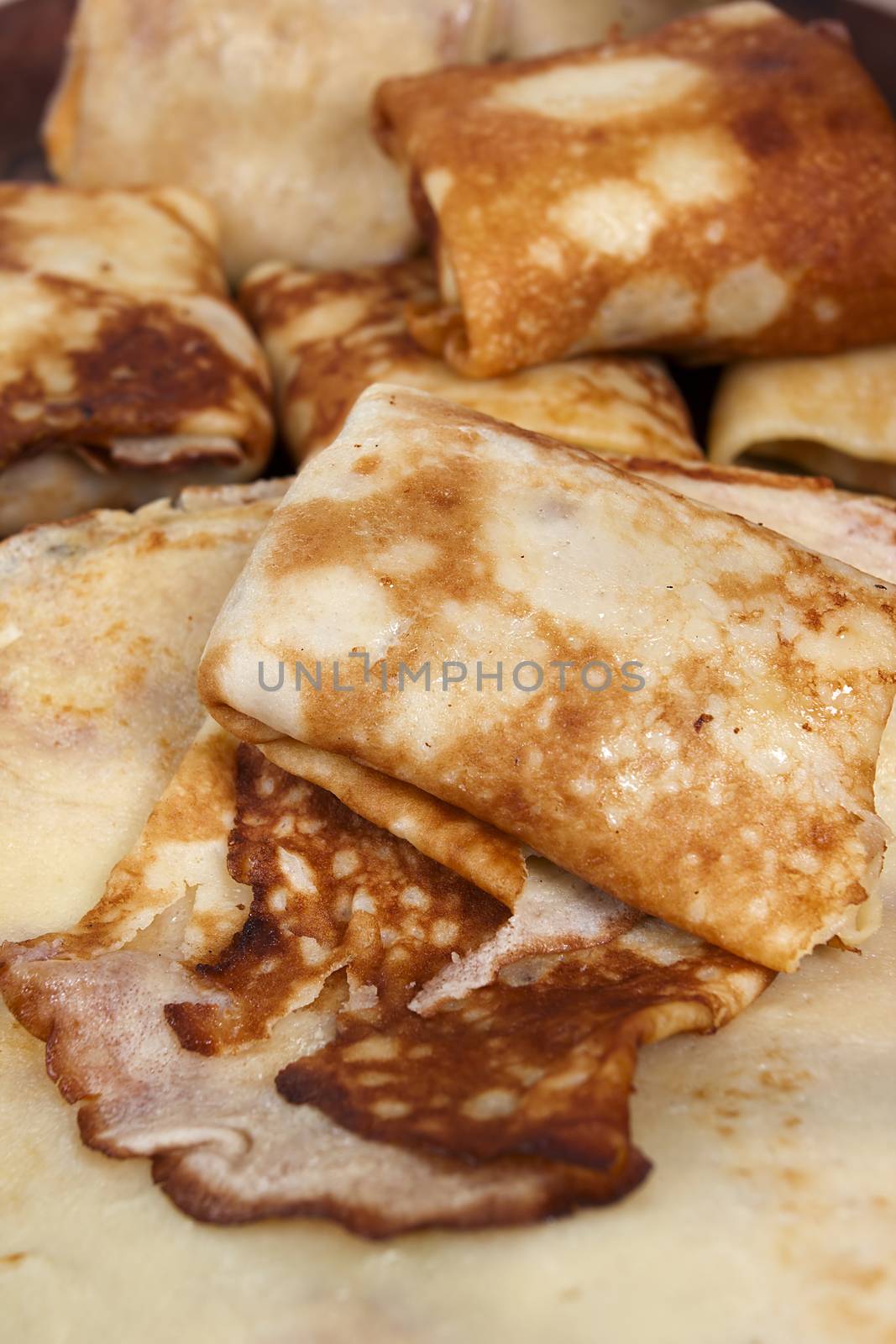 Freshly baked pancakes and wrapped with meat