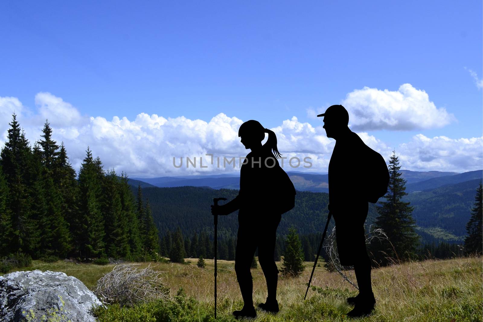 Couple of tourists hiking in mountains landscape