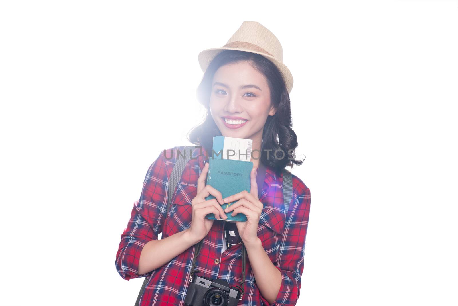 Woman travel. Young beautiful asian woman traveler holding passport and air ticket standing over white.