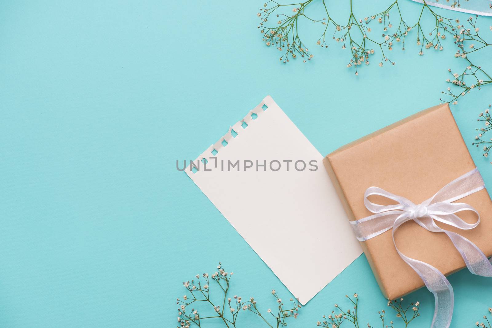 Kraft paper gift box tied with white ribbon and flowers for moth by makidotvn