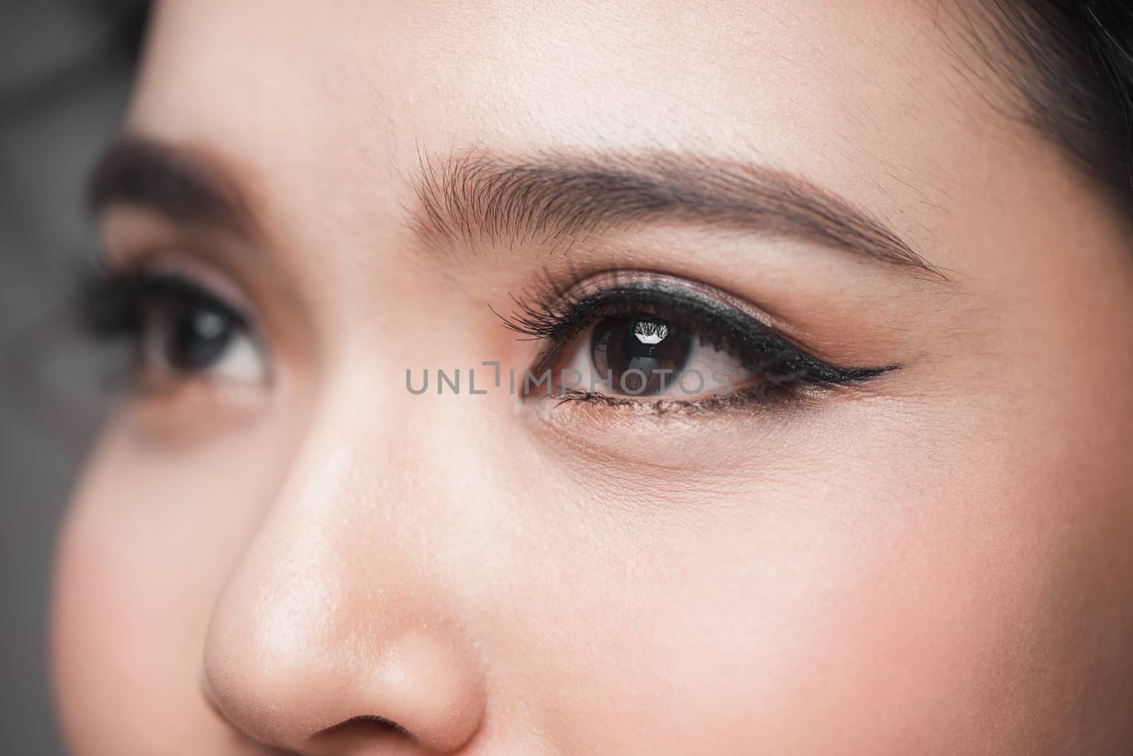 Asian model eye close-up with long eyelashes. Selective focus by makidotvn