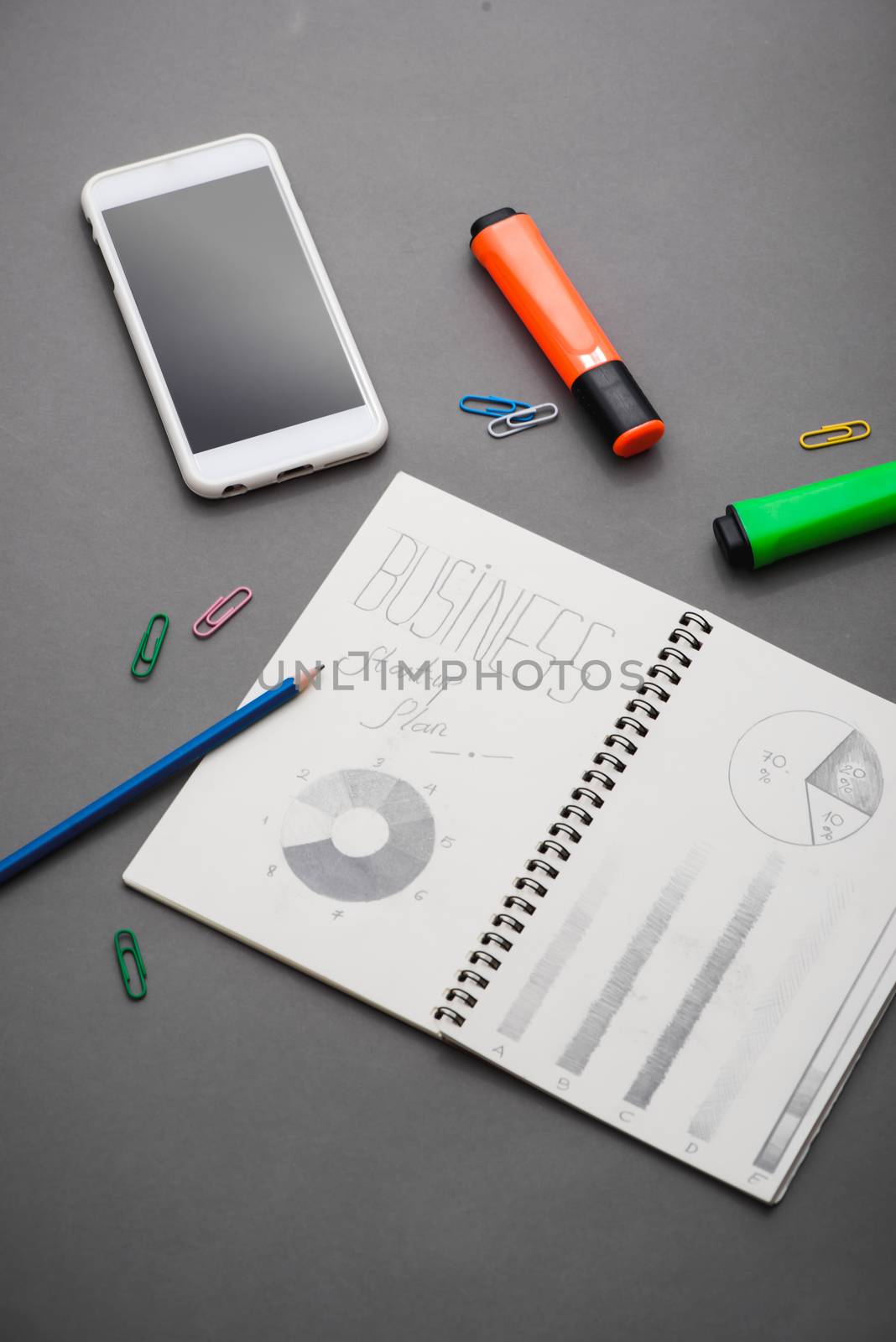 Creative sketch in spiral notepad with laptop on desk. Business  by makidotvn