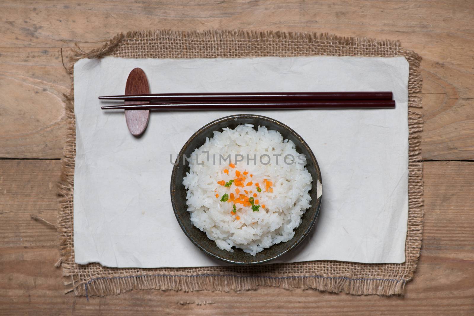 Close up of cooked rice in wooden in bowl on wooden table