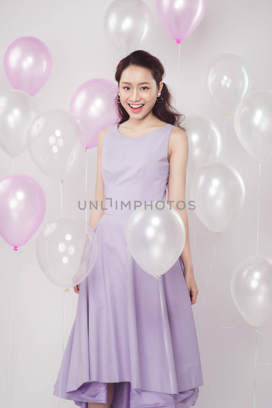 Asian pretty fashionable woman with pastel balloons by makidotvn