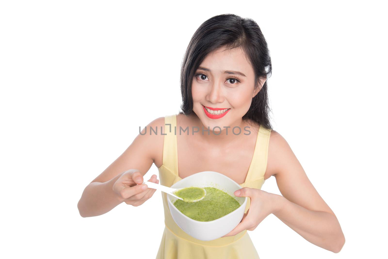 Portrait of asian woman eating/holding a plate of green vegetabl by makidotvn