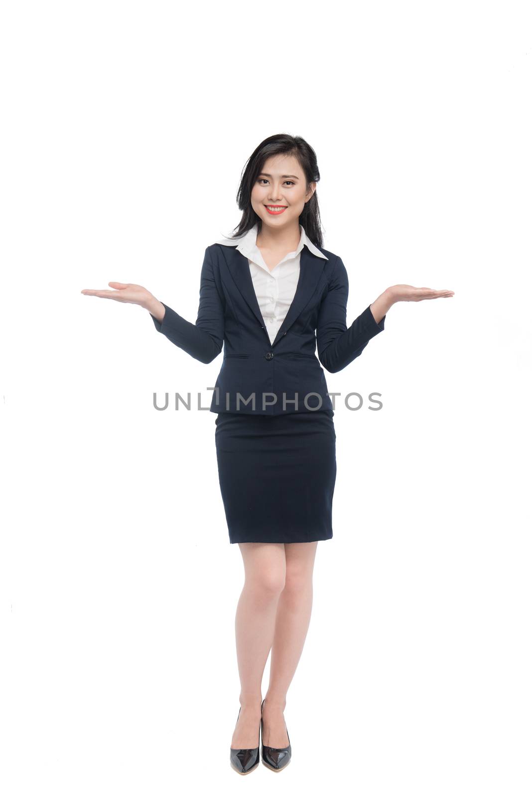 Full body of an attractive young businesswoman showing by hands isolated on white.