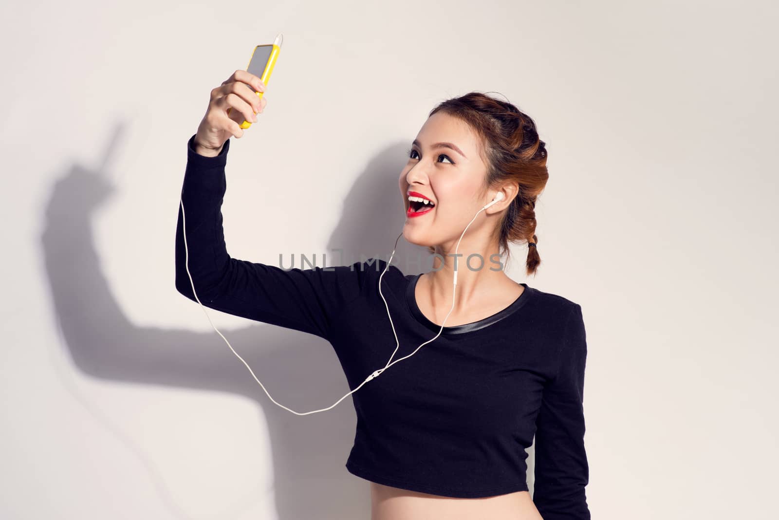 Fashion lifestyle portrait of young happy pretty woman listening favorite music,stylish vintage outfit. white background
