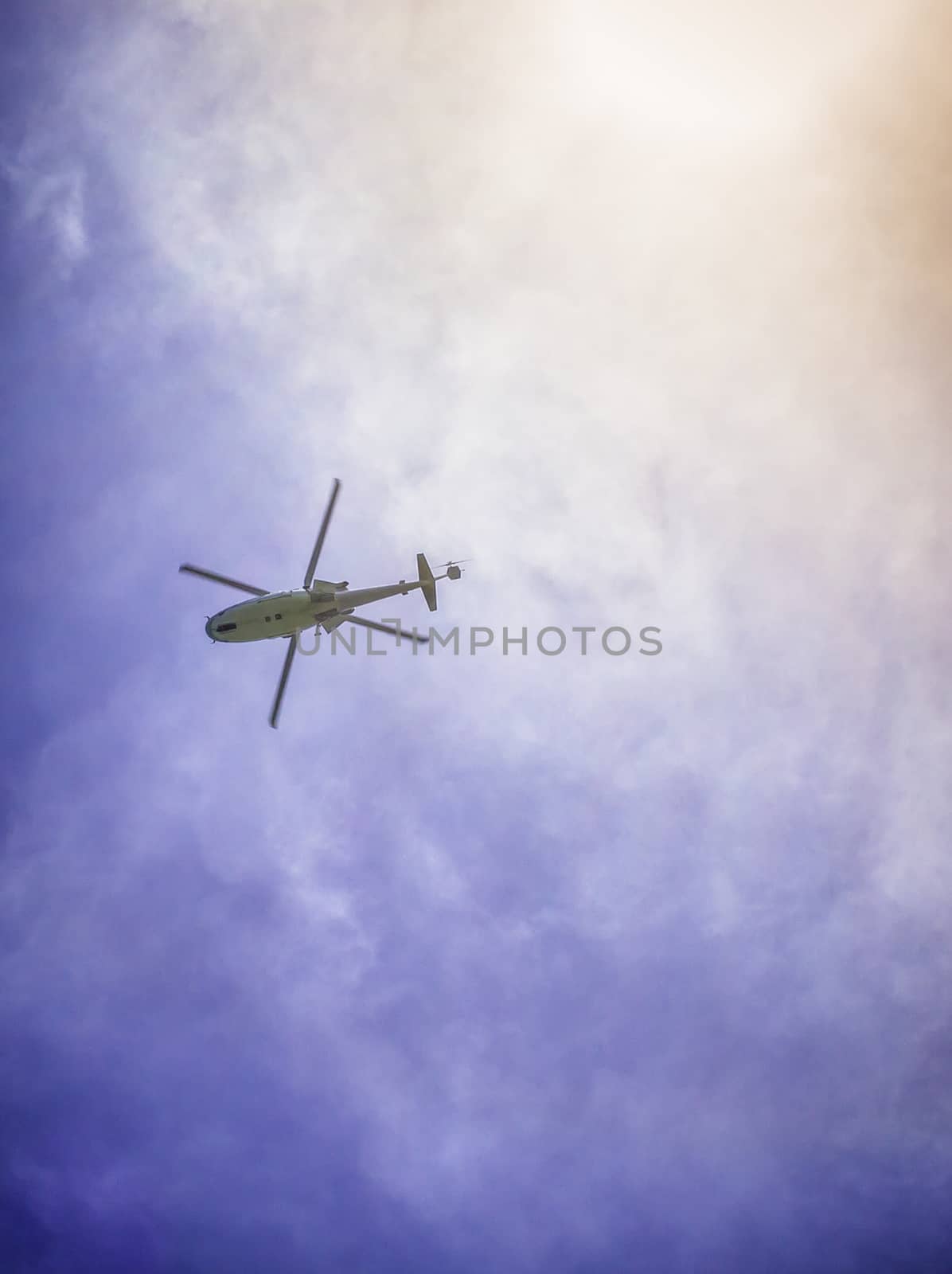 Helicopter flying againts with the blue sky