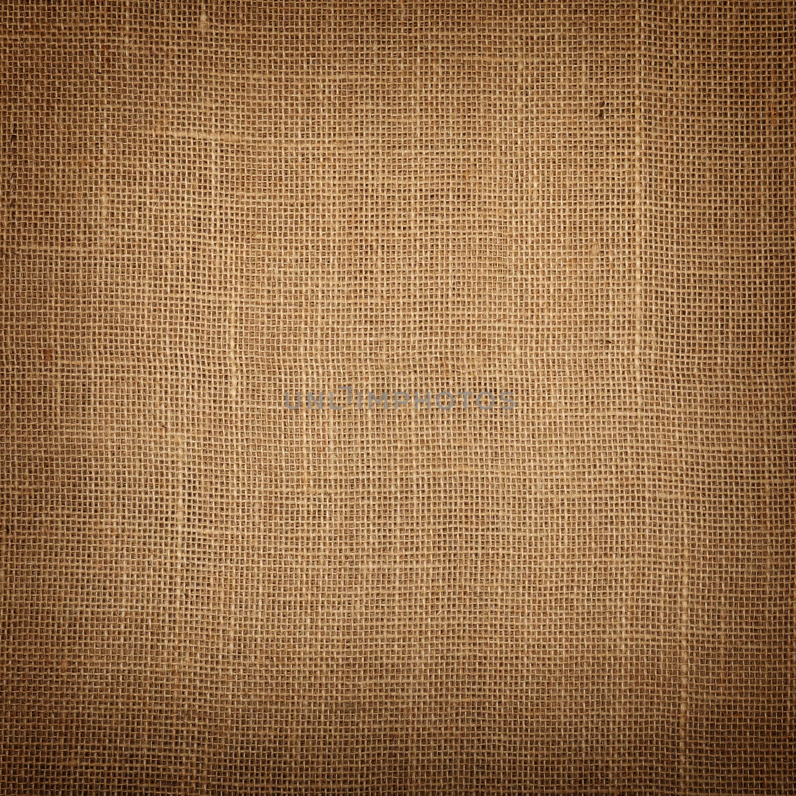 Brown burlap jute canvas background with shade by BreakingTheWalls