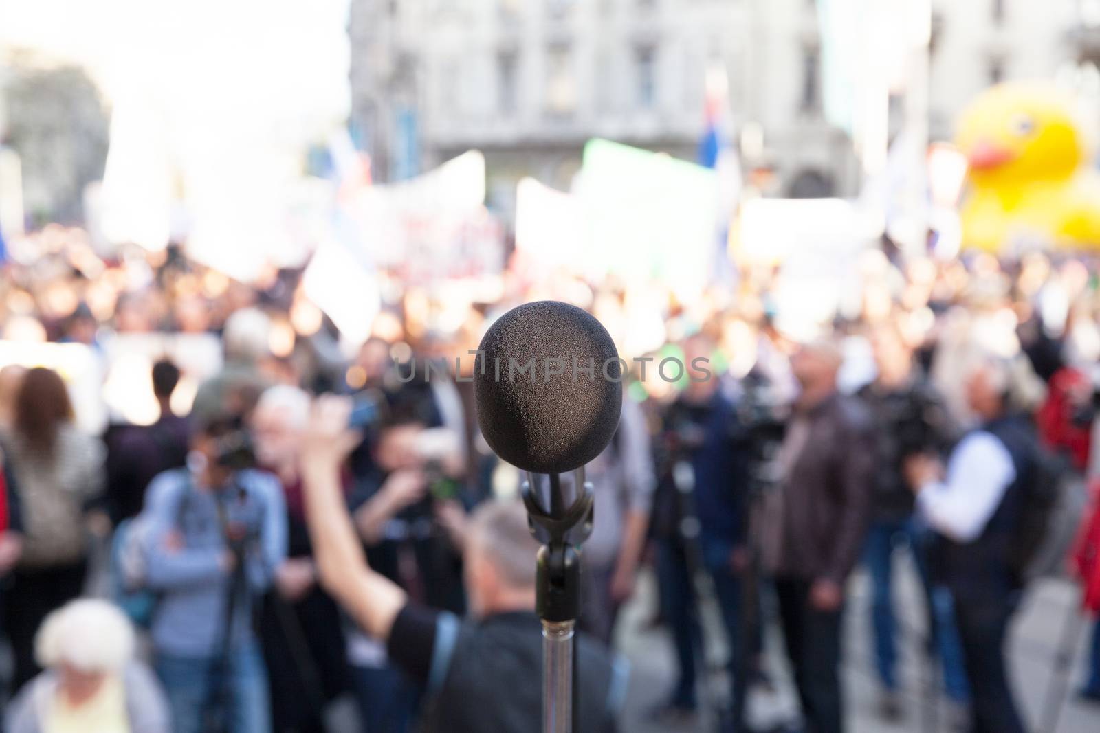 Microphone in focus, blurred crowd in background