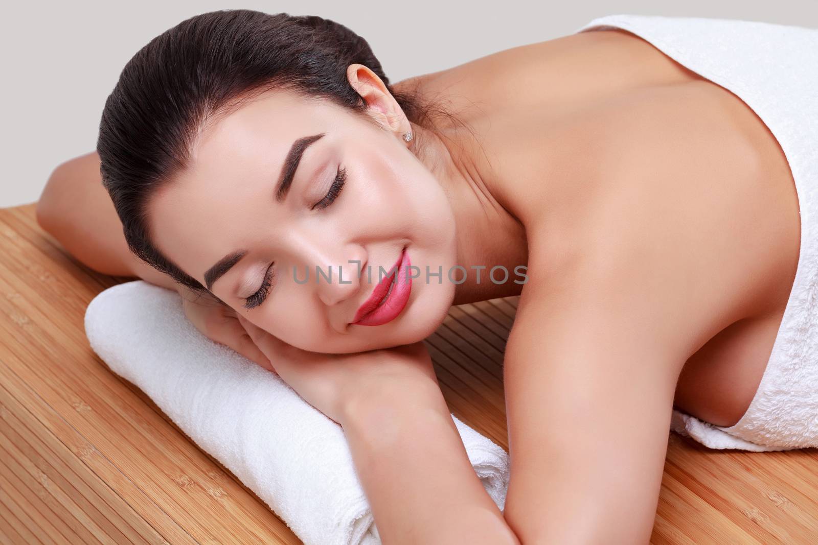 Young beautiful woman relaxing at spa salon