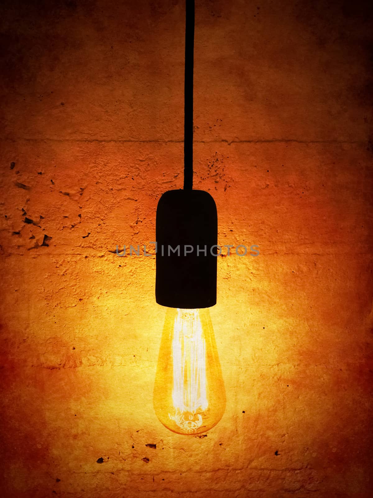Light bulb on vintage orange background. Design with retro feel.