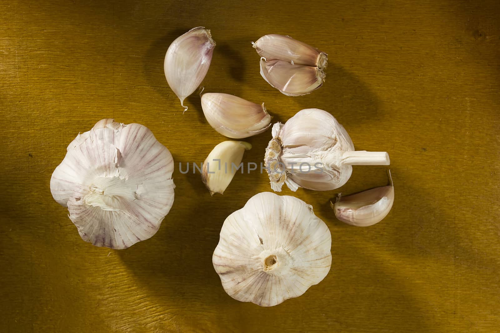 Ripe fresh garlic on a brown wooden table