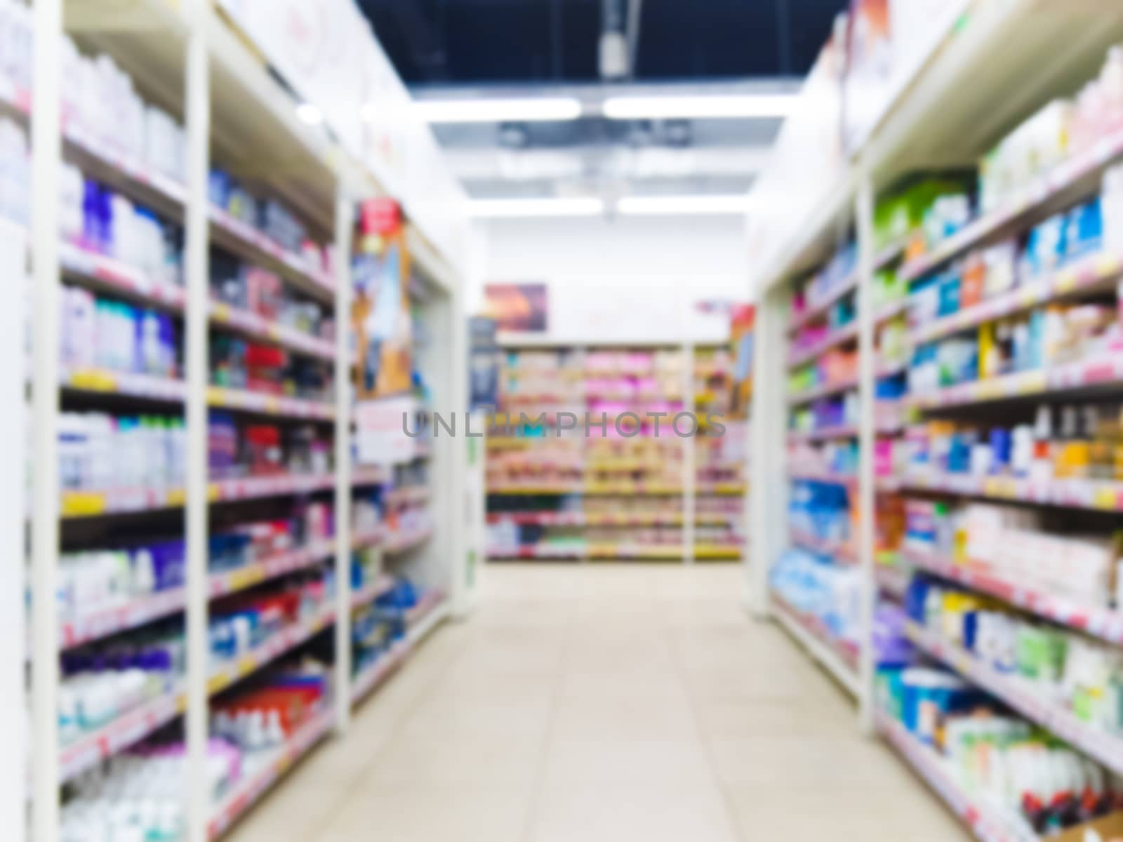 Abstract blurred supermarket aisle with colorful shelves as background