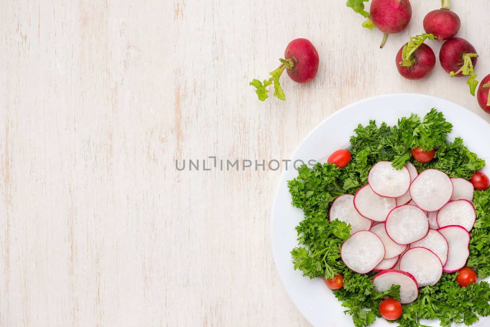 Homemade fresh radishes vegetable salad on table. Close-up. by makidotvn
