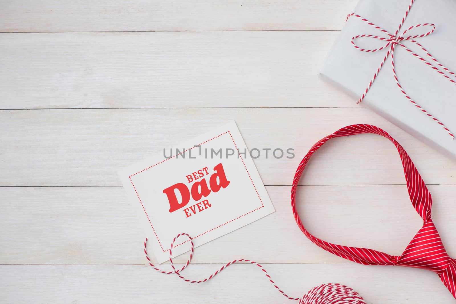 Happy Father's Day with striped tie on wooden background. Greeti by makidotvn