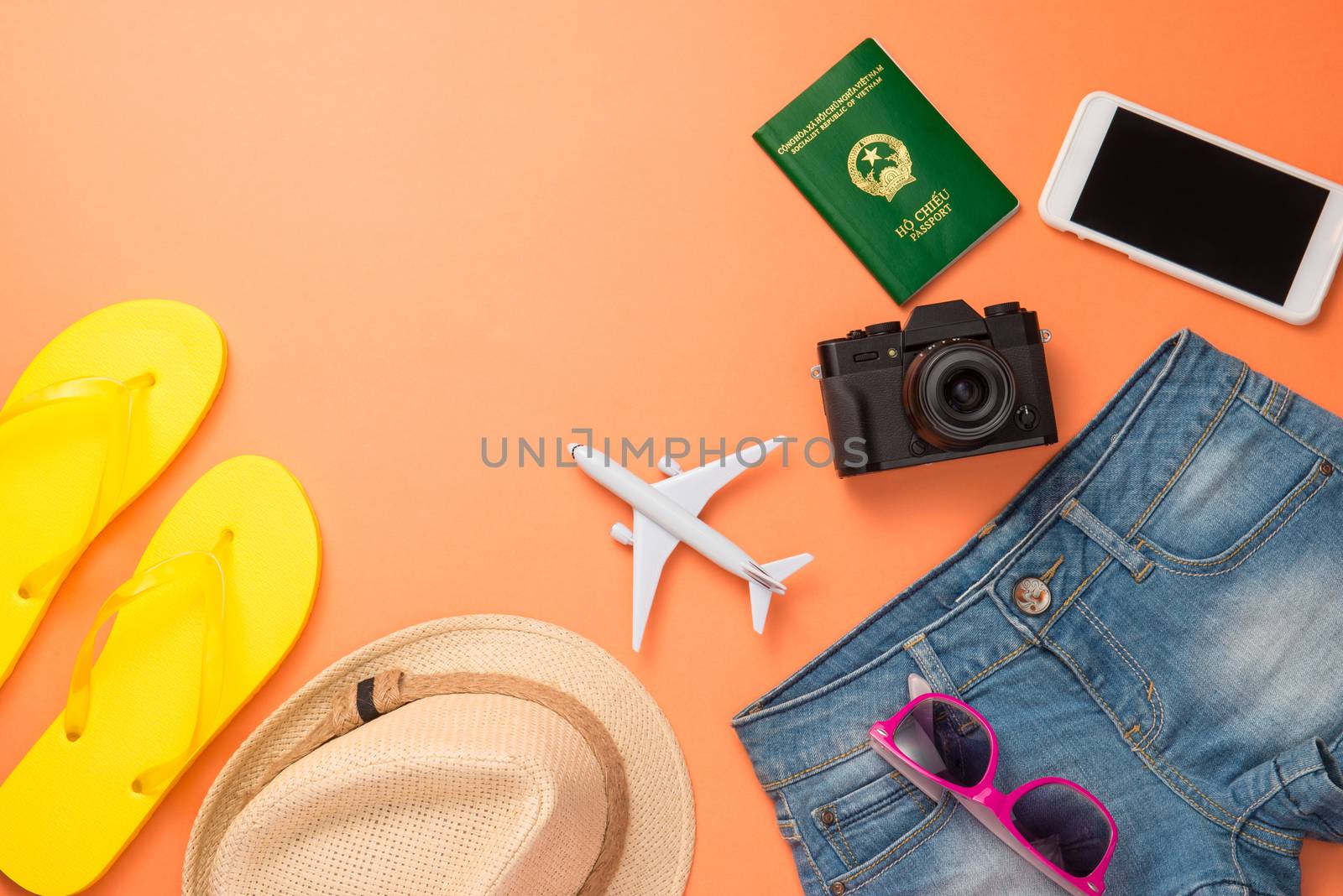 Summer traveling concept. Vacation accessories on orange backgro by makidotvn