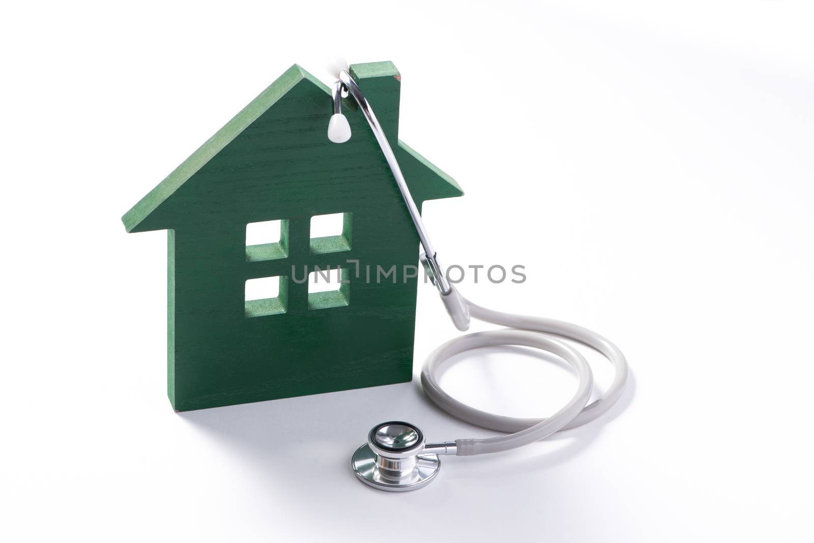 Concept of family medicine. House with stethoscope isolated on w by makidotvn