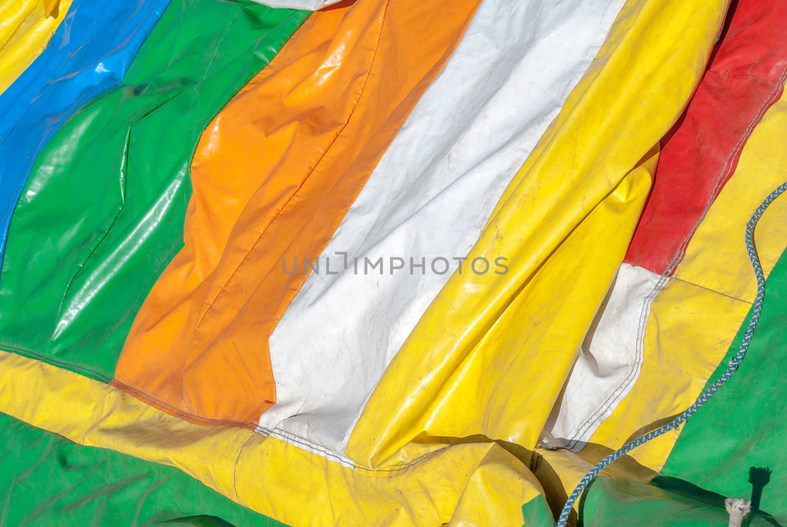 rumpled colored rubber gloth, inflatable attraction, a beautiful sunny day