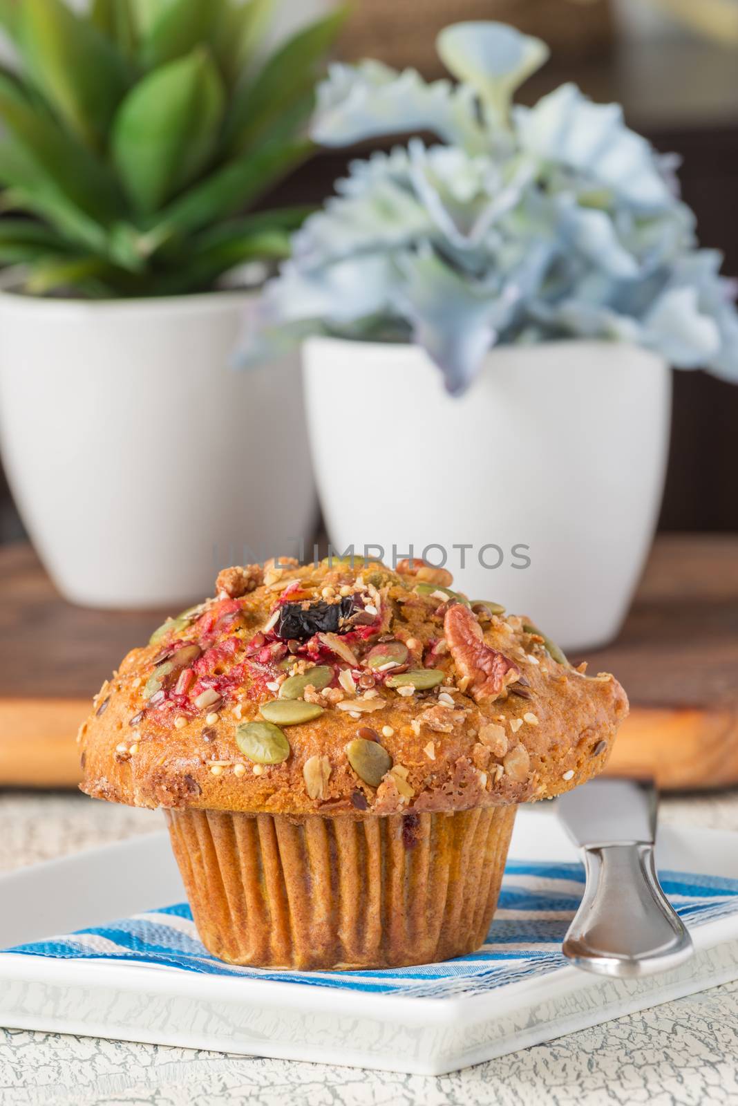 Closeup view of a fresh cranberry pumpkin muffin.